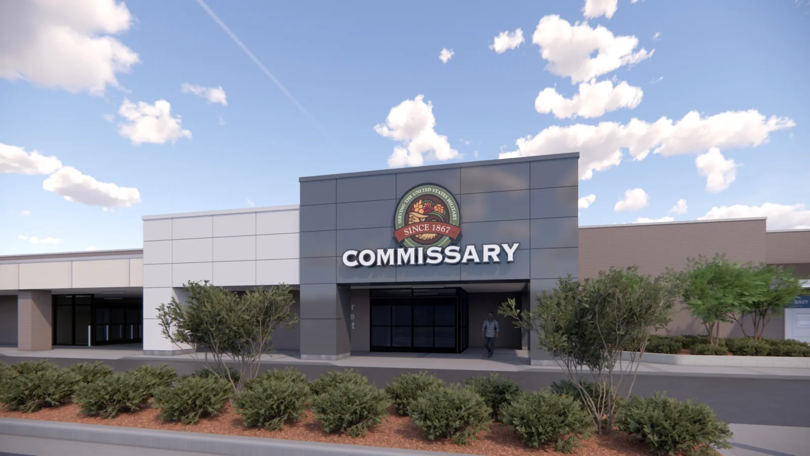 Rendering of the Commissary entry: a dark metal-panel portal carrying the Commissary emblem and lettering, set into the long light-grey storefront behind landscaped beds.