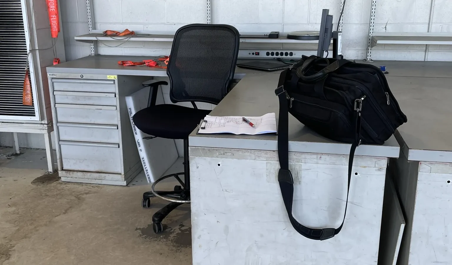 A maintenance workstation inside an aircraft maintenance hangar at NAS Pensacola, part of the Package 7A roof replacement.