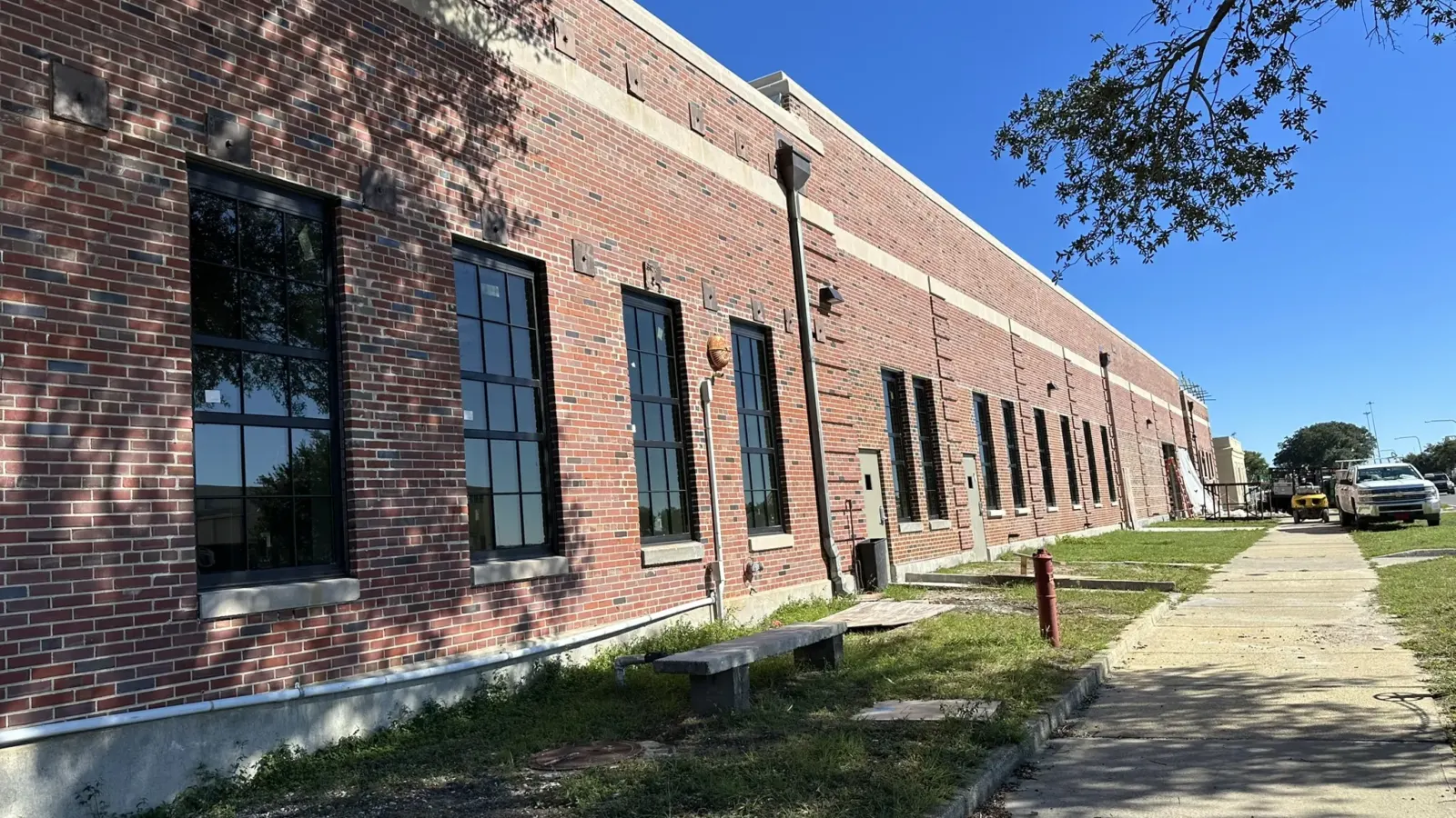A 1941 brick training building at NAS Pensacola after its Hurricane Sally Package 7A repairs, with its new windows installed.