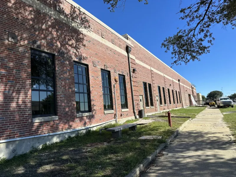 A 1941 brick training building at NAS Pensacola after its Hurricane Sally Package 7A repairs, with its new windows installed.